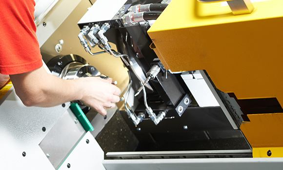 worker adjusting machinery controls in a manufacturing setting showcasing precision engineering skills and techniques for enhanced production efficiency