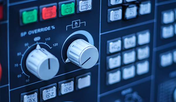 control panel with various knobs and buttons showcasing settings for precision manufacturing processes and speed adjustments related to 5 different operations
