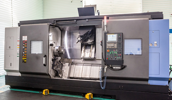 CNC machining center with control panel and tool holder in a manufacturing facility showcasing precision machinery and advanced technology for manufacturing processes