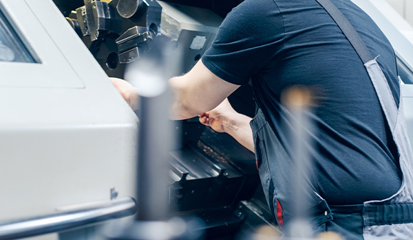 worker operating industrial machinery in a manufacturing environment with precision tools for producing components and parts 2 manufacturing techniques