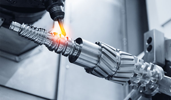 metalworking process showcasing a machine tool performing precision machining on a metallic part designed for a five axis CNC system